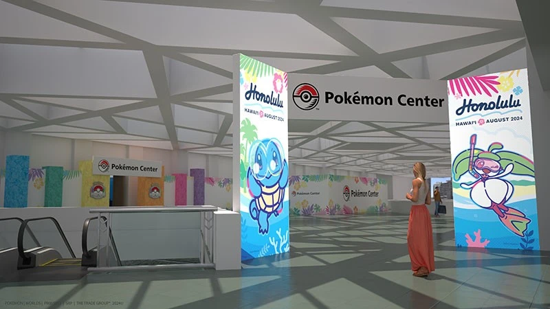 A women stand in front of a Squirtle banner